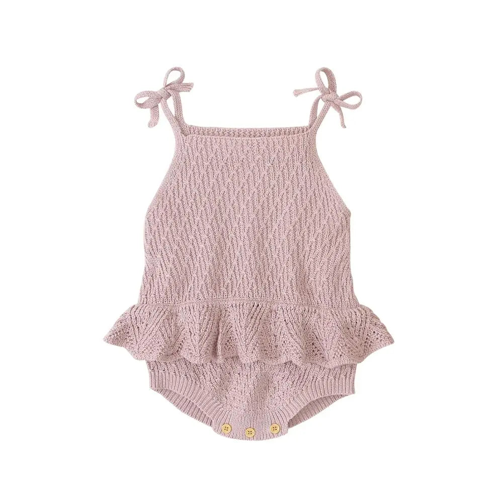 Pink knitted baby romper with bow straps