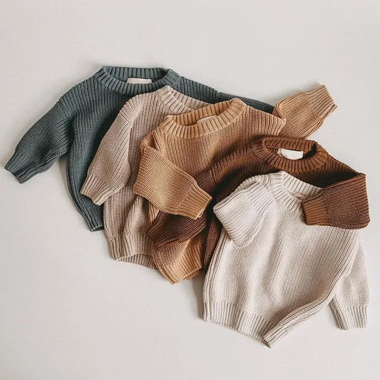 Four knit sweaters in different colors