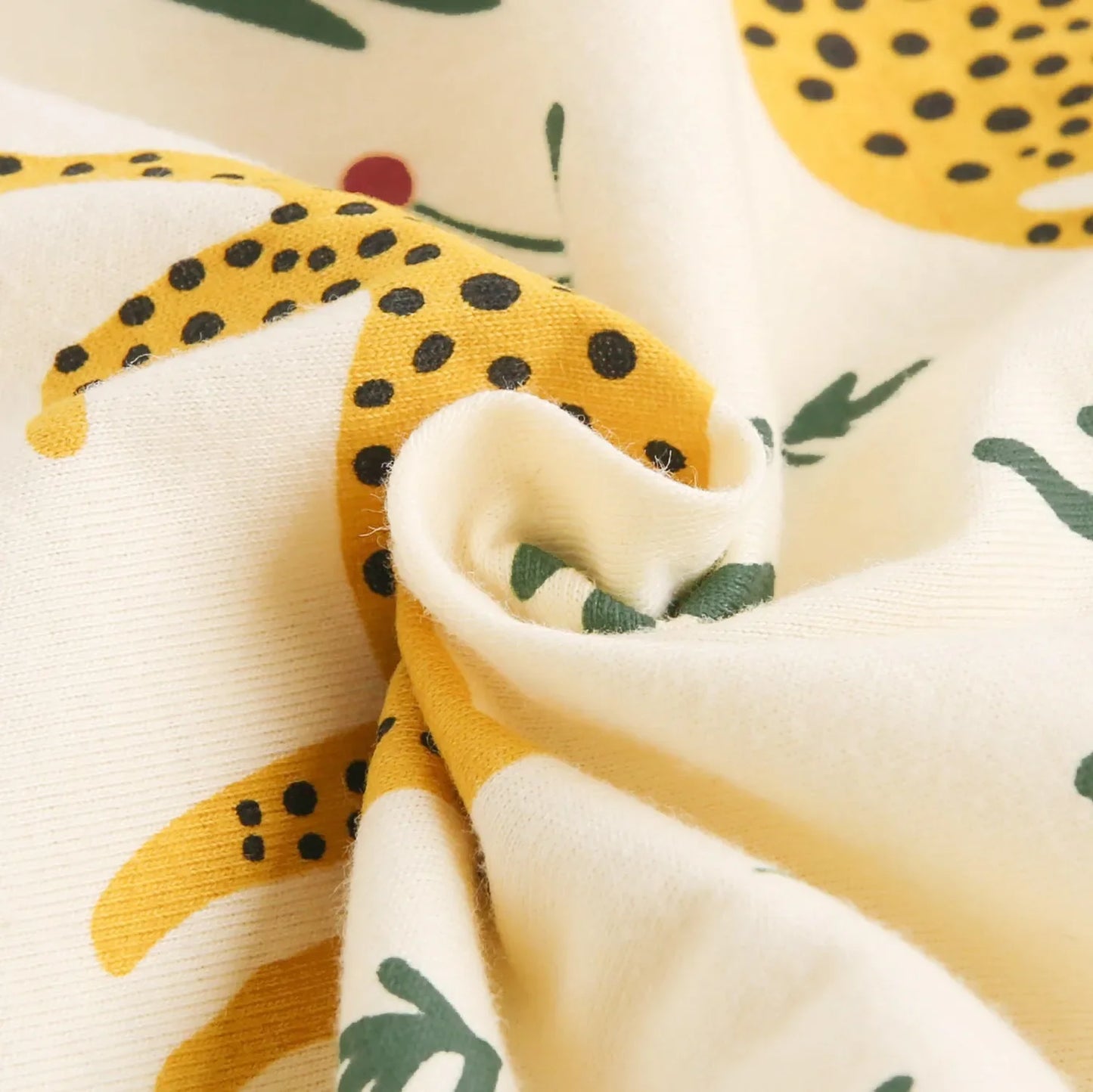 Close-up of fabric with yellow and black pattern resembling a cheetah,