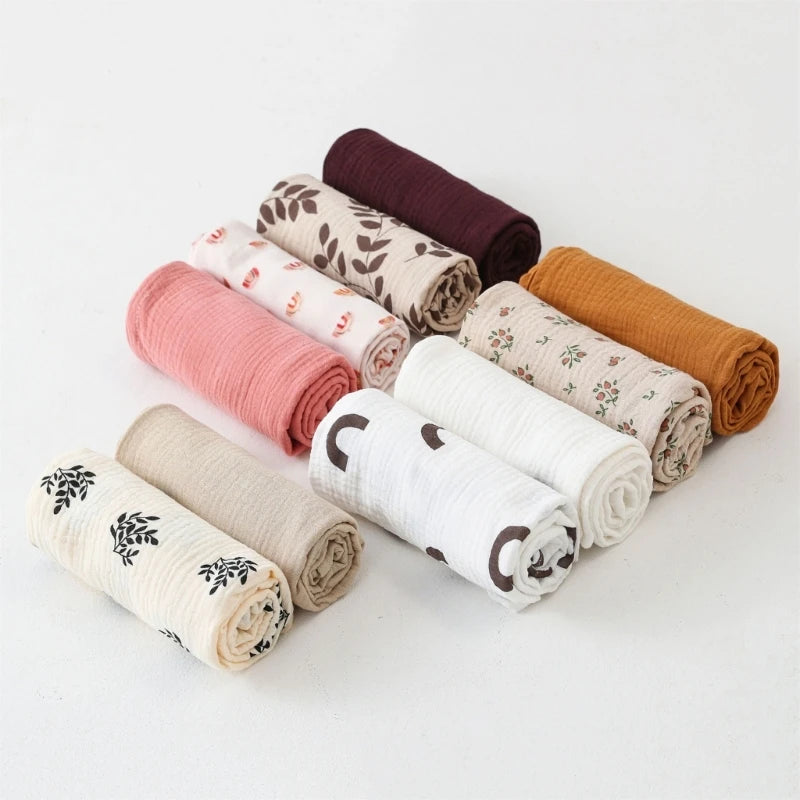 Set of rolled-up fabric swaddles in various colors
