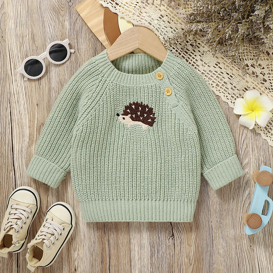 Green knitted sweater with a hedgehog design