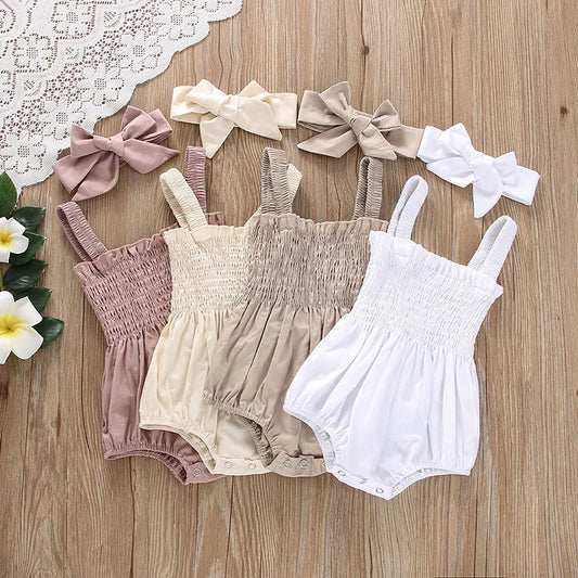 Three baby rompers in pink, beige, and white with matching headbands