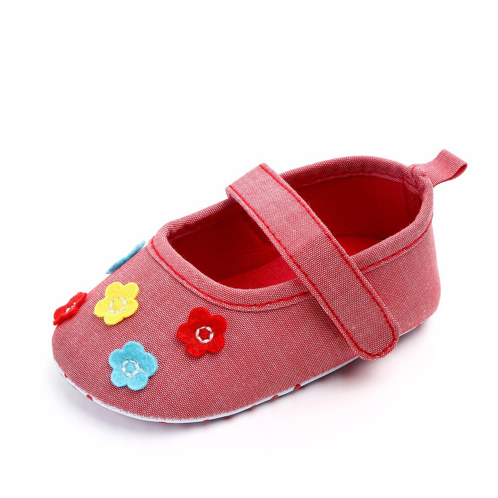 Light coloured red canvas shoes with flowers, ideal for baby girls or toddlers