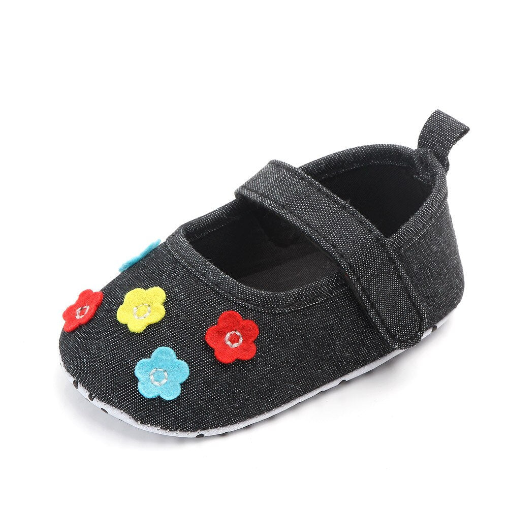Faded black look canvas baby girl shoe with colourful flowers