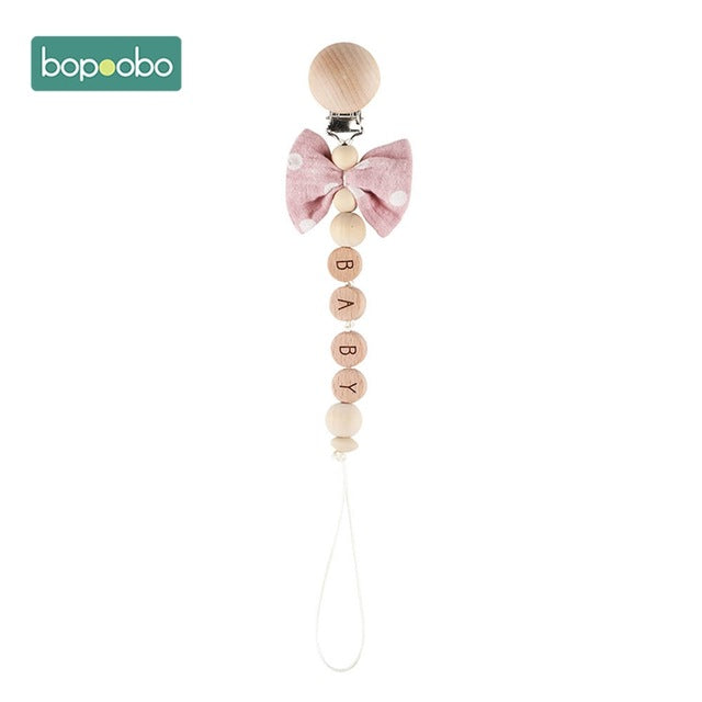 Wooden balls with the word baby dummy chain clip
