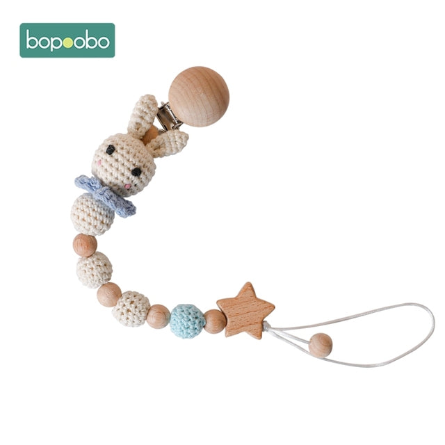 Very cute knitted rabbit with knitted balls on a dummy chain clip