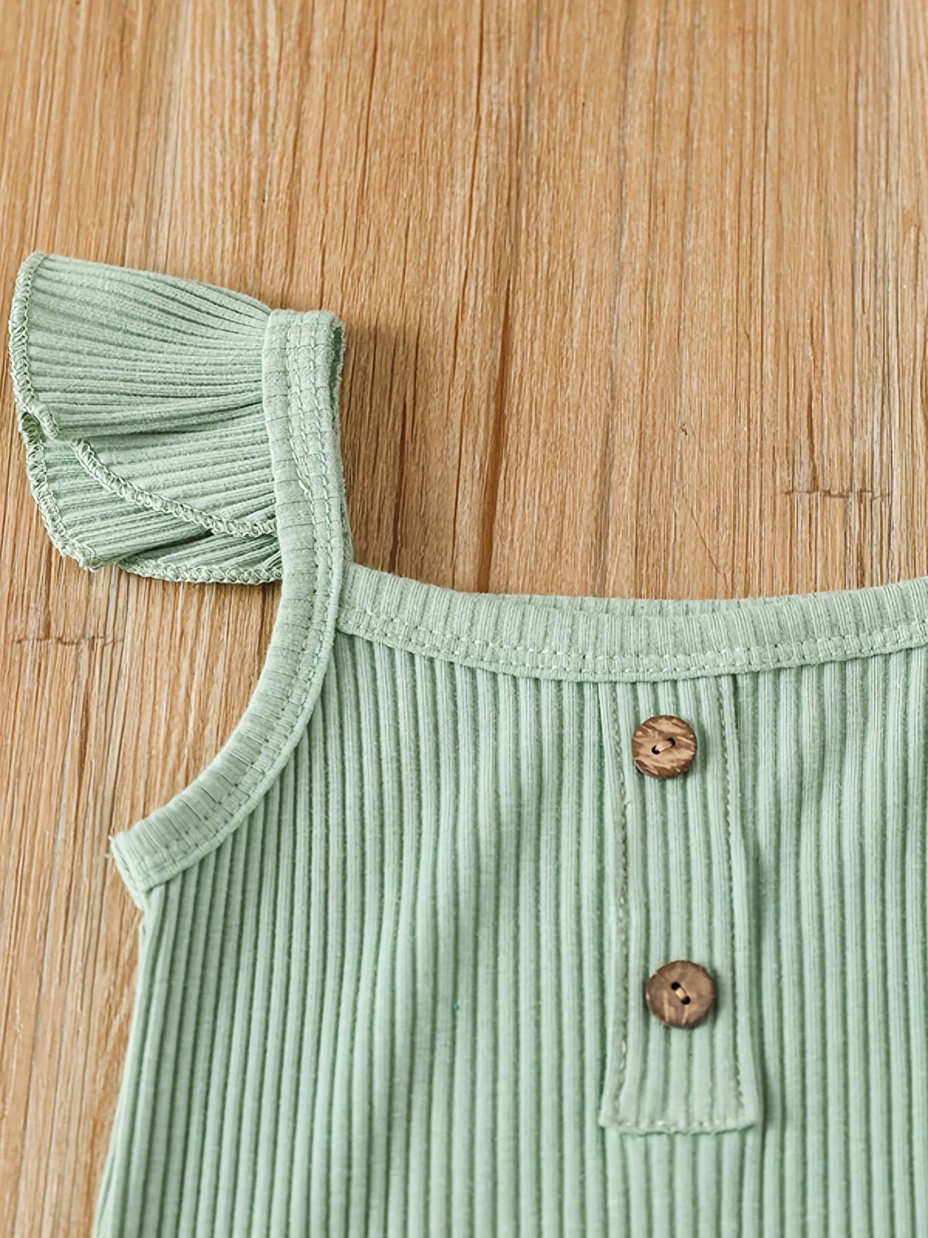 Green ribbed top with ruffled shoulder 