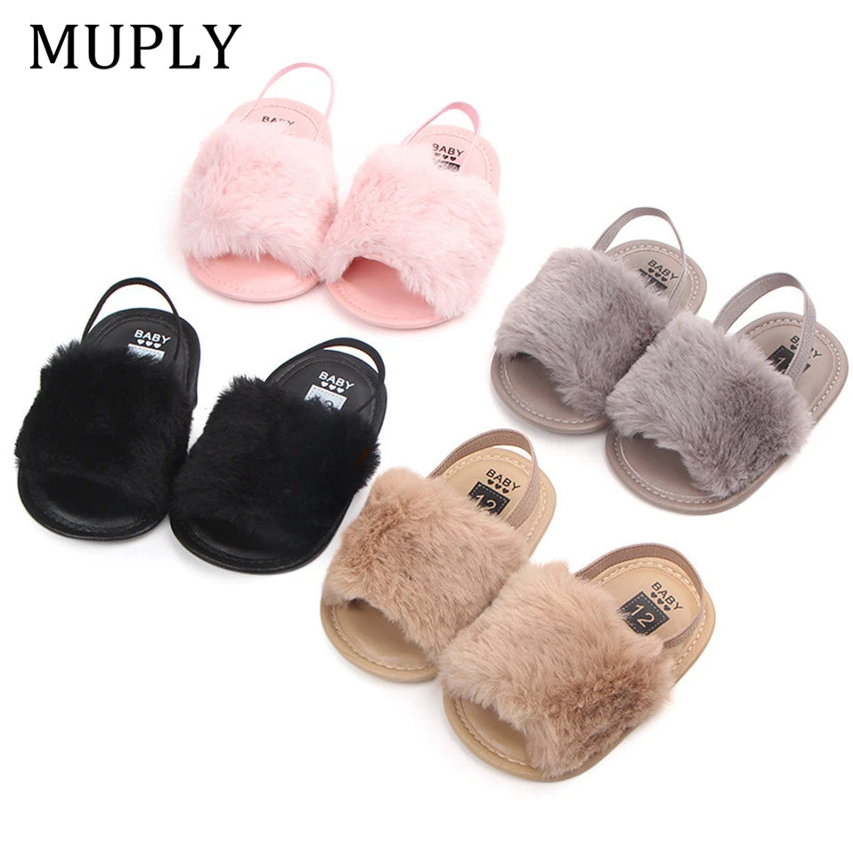 Set of four pairs of fluffy slippers in black, pink, gray, and brown 