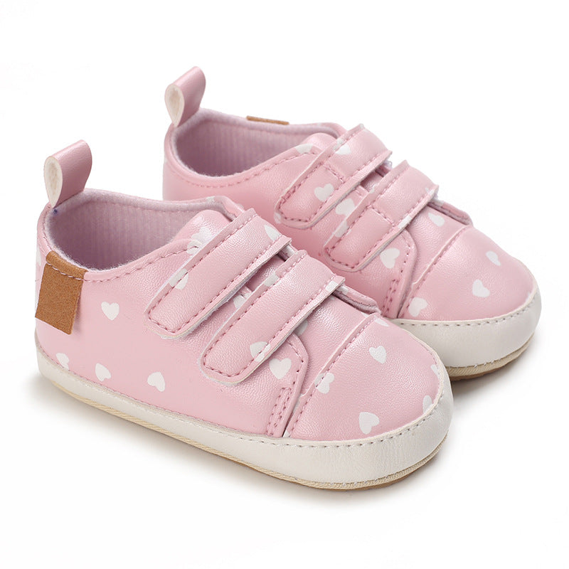 Pink baby shoes with heart patterns