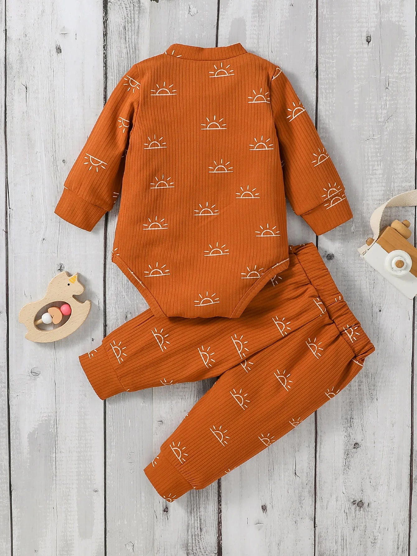 Orange children's outfit with sun pattern 