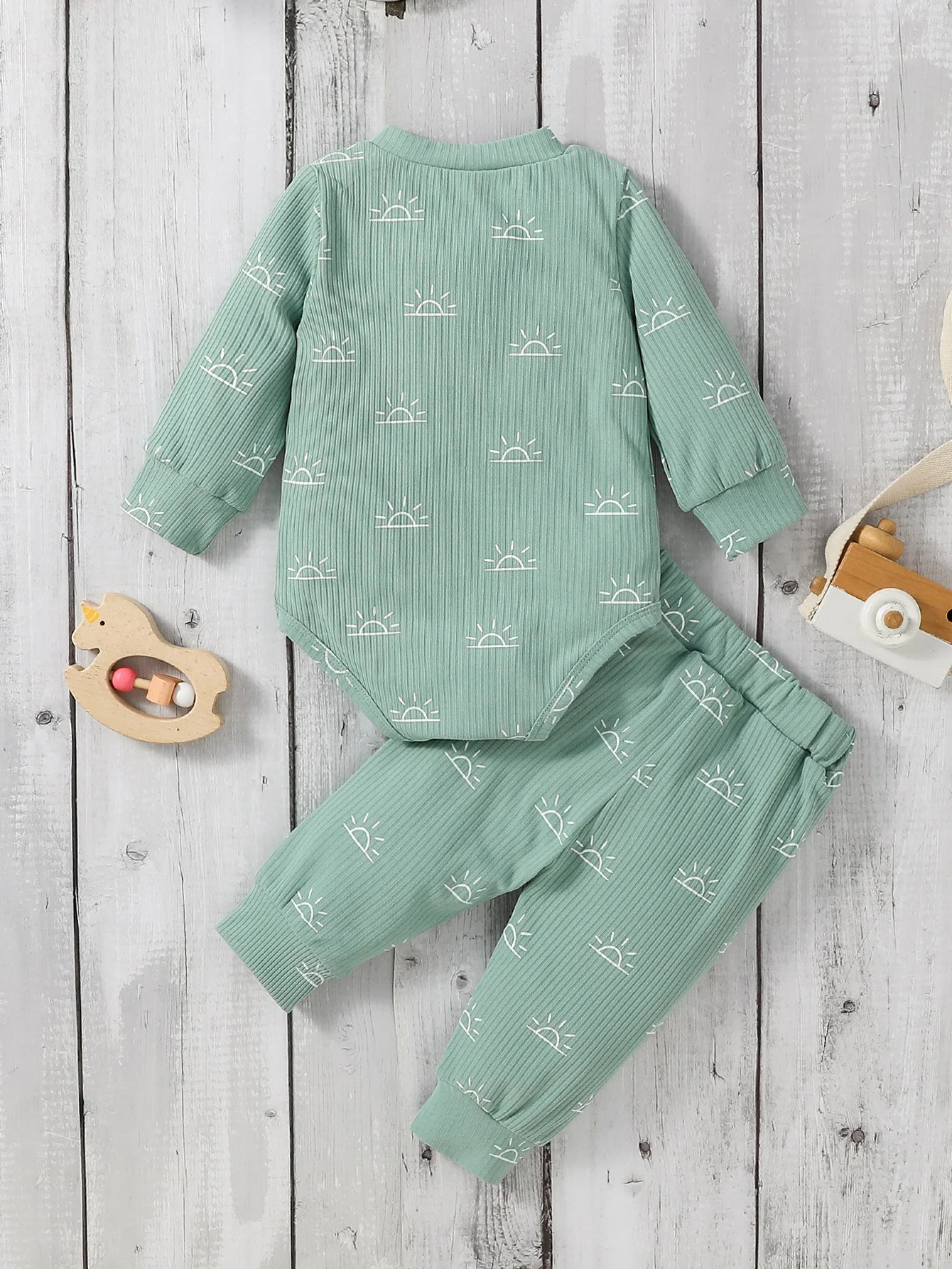 Green children's outfit with white patterns 
