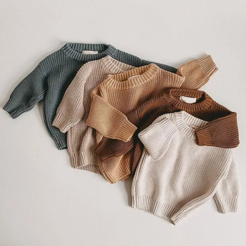 Four knit sweaters in different colors 