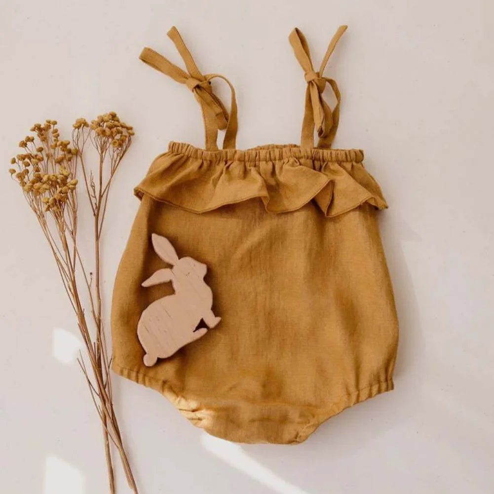 Warm mustard colored baby girl romper suit