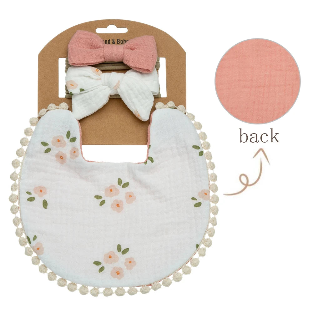 Peachy colored flowers on a gorgeous baby girl bib