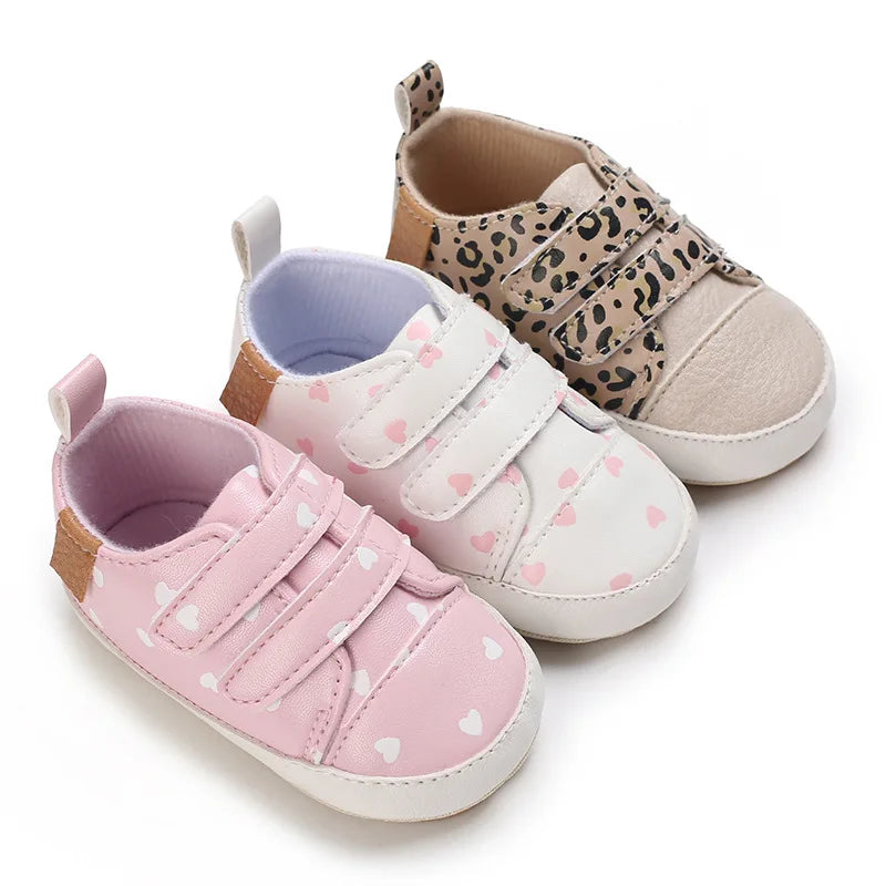 Three pairs of baby shoes with different designs