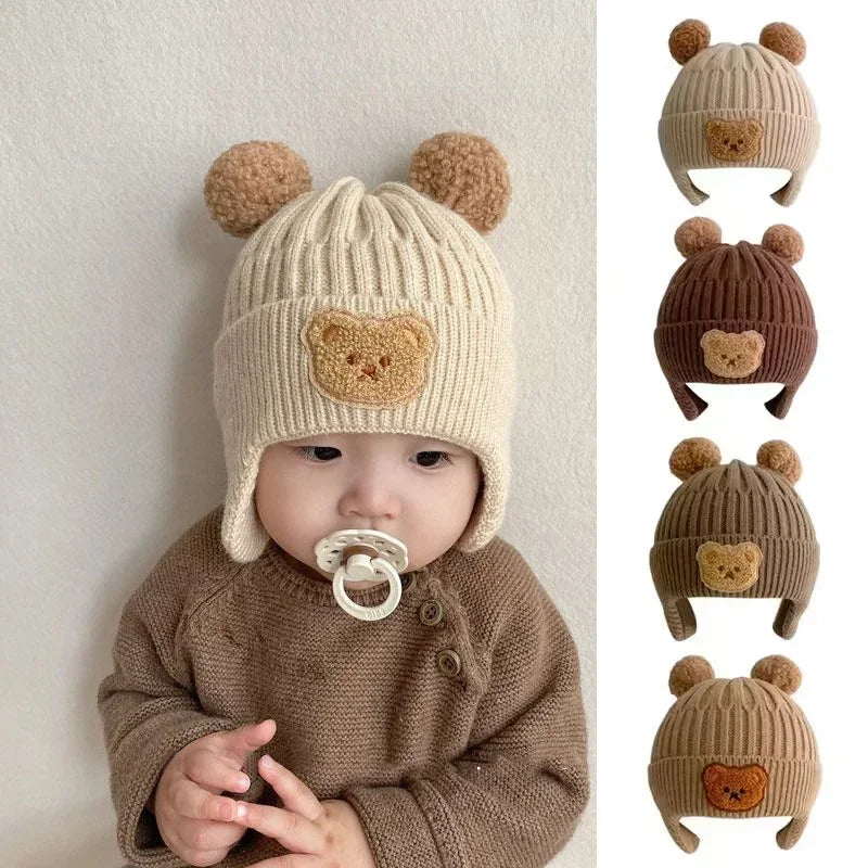 Baby wearing a beige knit hat with bear ears 