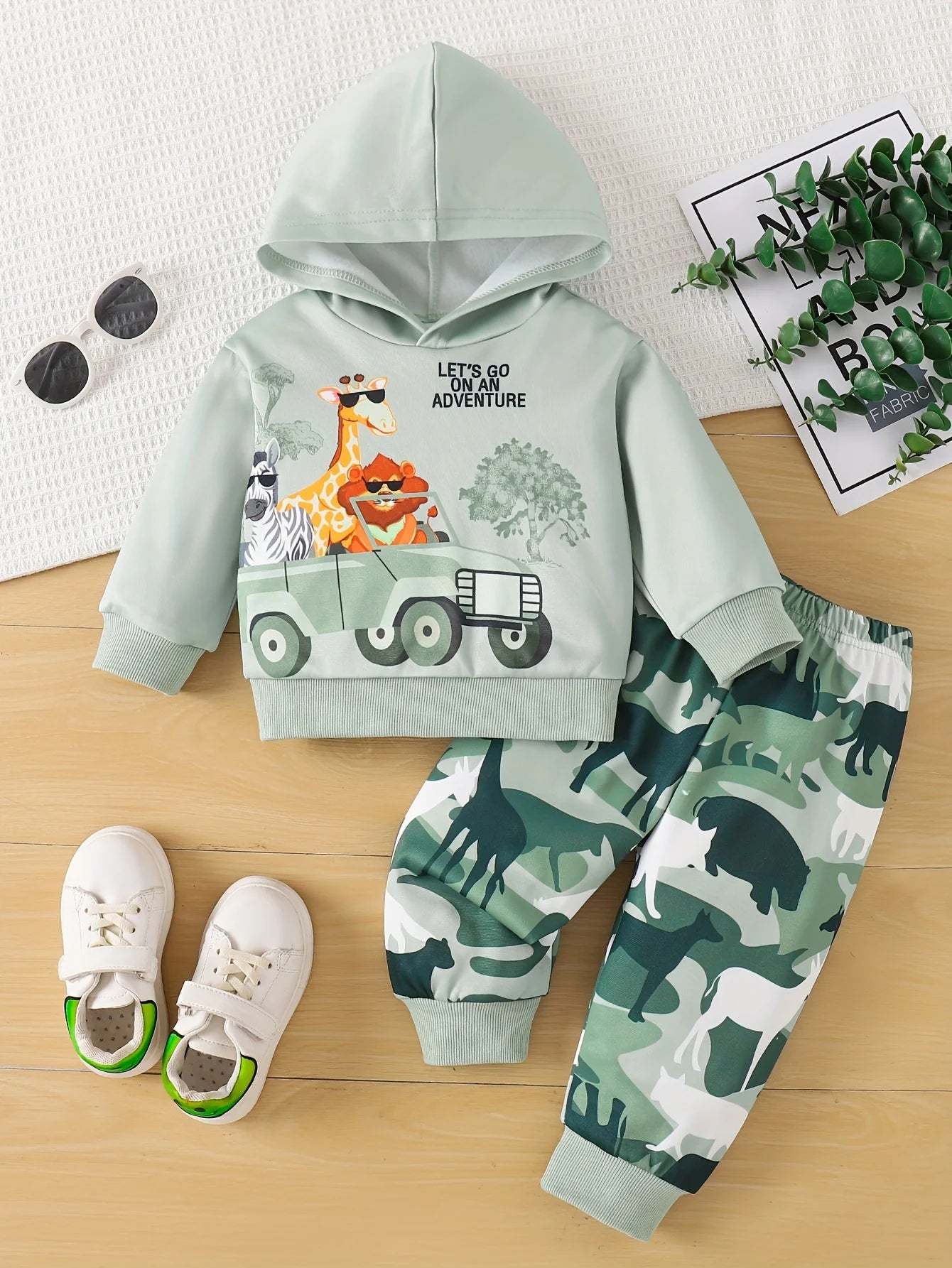 Children's outfit with hoodie and pants featuring animal prints 