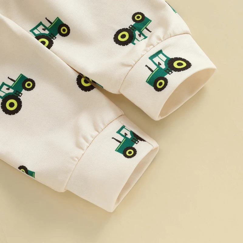 Close-up of a white fabric with green tractor patterns 