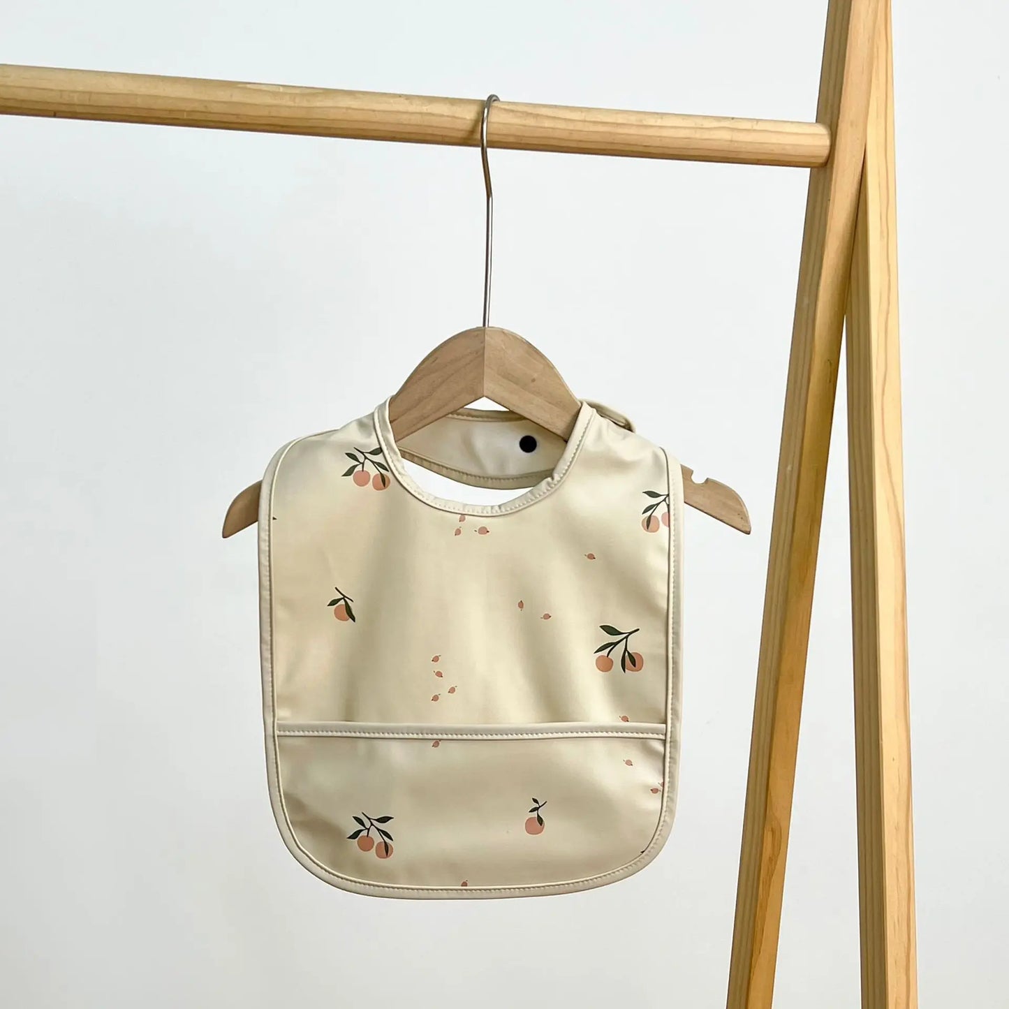 Beige baby bib with floral pattern 