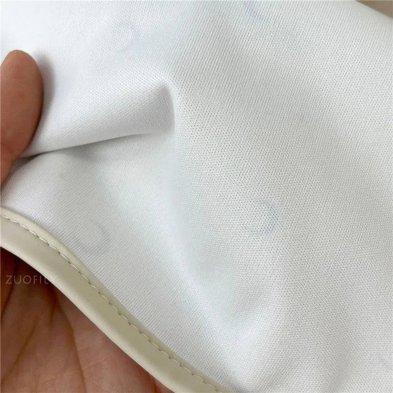 Close-up of white fabric, showing texture and stitching details.