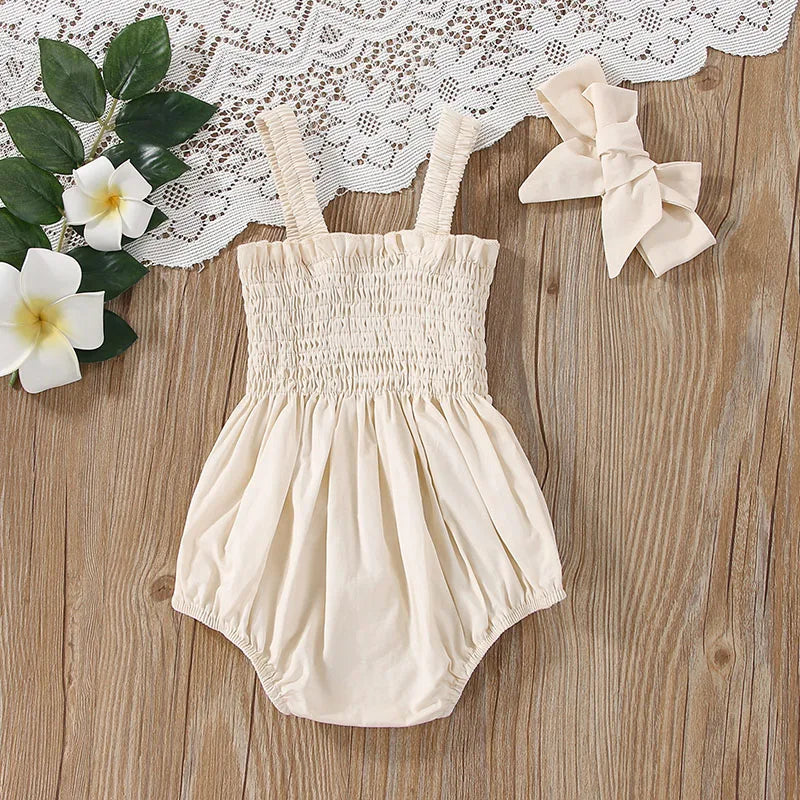 Beige baby romper with straps 