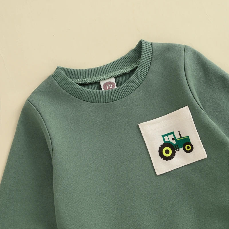 Green sweatshirt with a tractor patch 