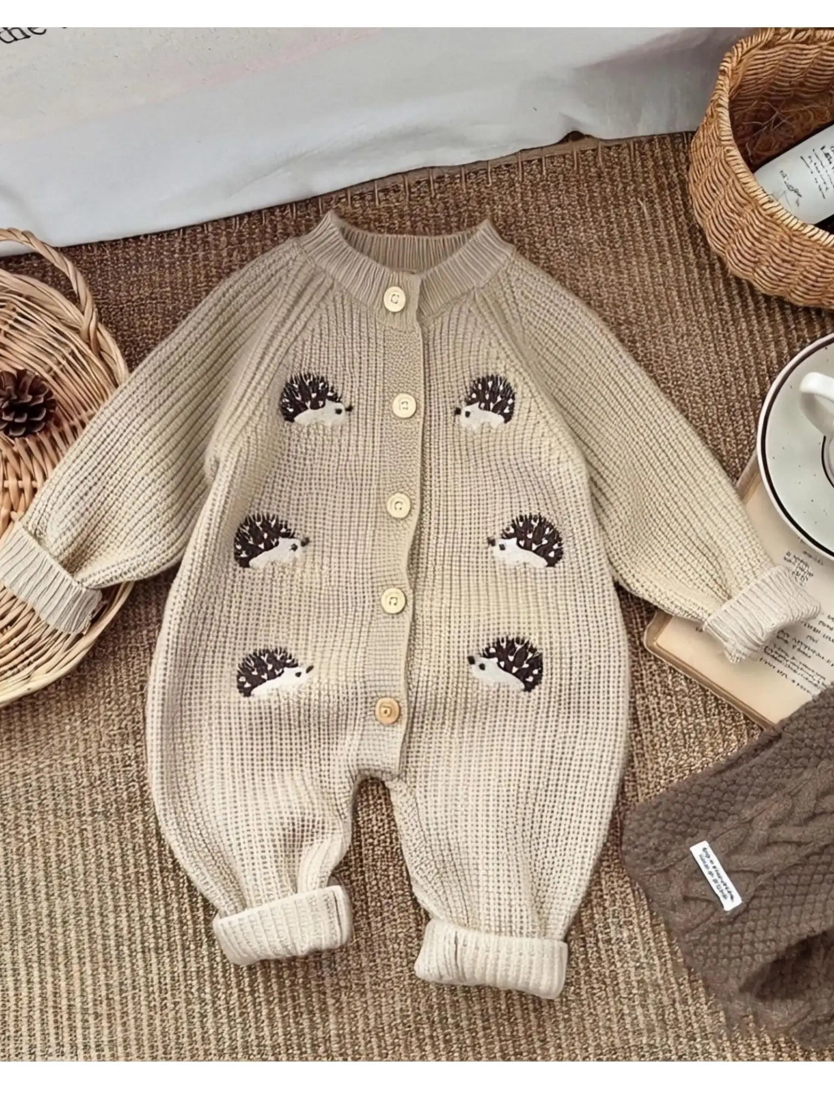Beige baby romper with hedgehog designs 