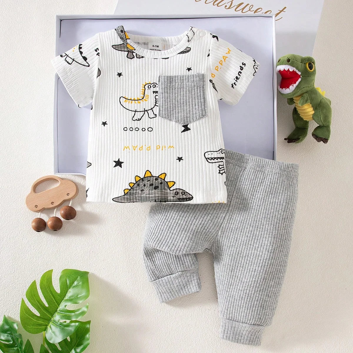Baby outfit with dinosaur-themed shirt and pants