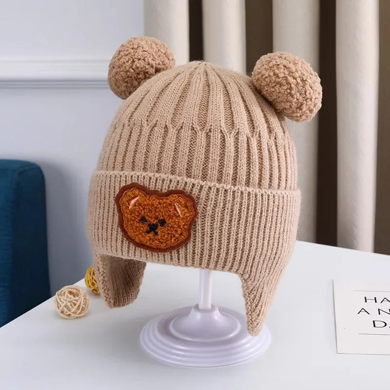 Knitted baby hat with bear ears and face 