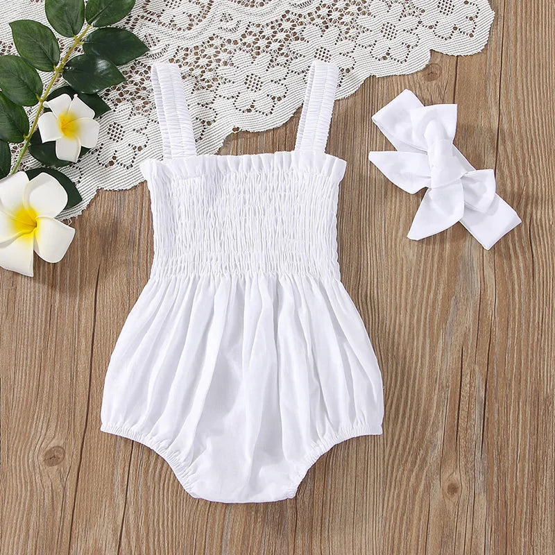 White baby romper with straps and matching headband